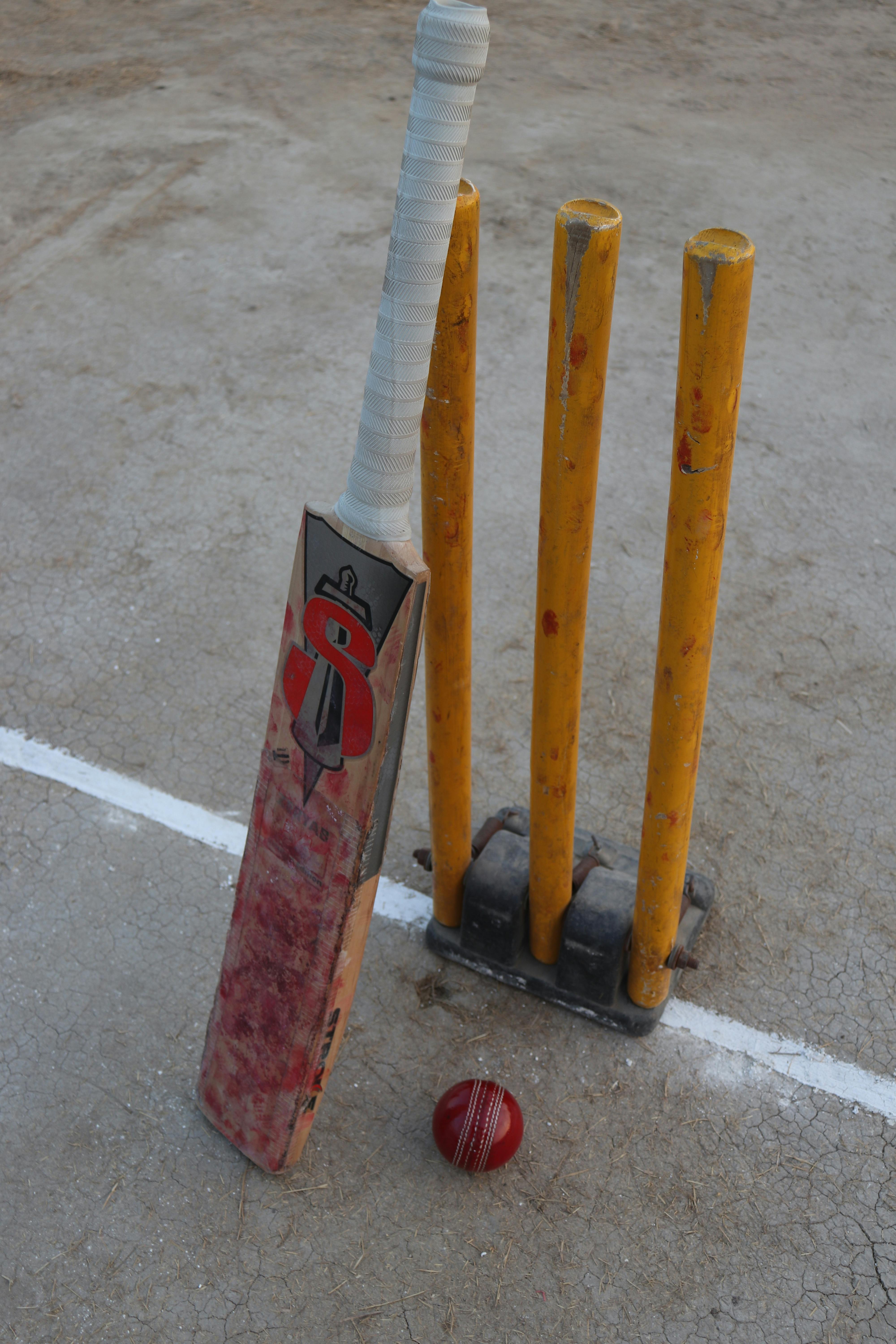 Cricket gear set out on the field for match setup